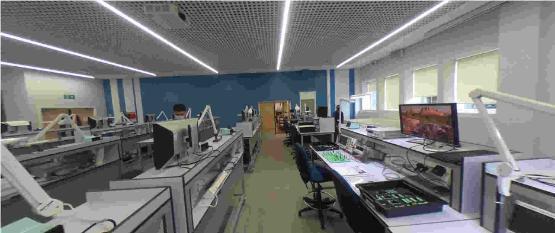 Electronics lab with rows of workbenches, oscilloscopes and computer workstations