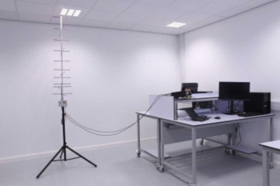 Yagi antenna on a tripod connected to ground station computers in the lab
