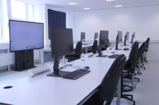 Teaching lab with student workstations facing an interactive smart screen
